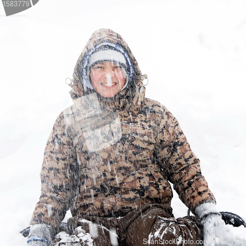 Image of Boy winter portrait at snowfall