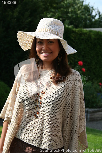 Image of Beautiful lady in hat and poncho