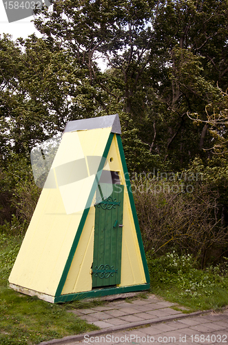 Image of Decorative outdoor toilet wc near park trees 