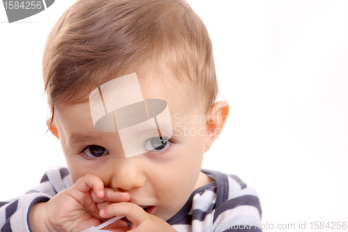 Image of beautiful baby biting, baby studio photo