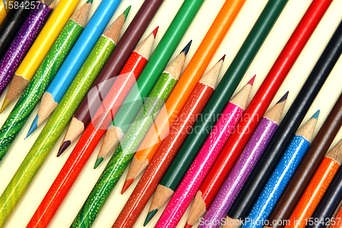 Image of Assortment of coloured pencils with shadow on white background