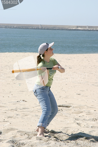 Image of playing baseball on the beach, sports photo