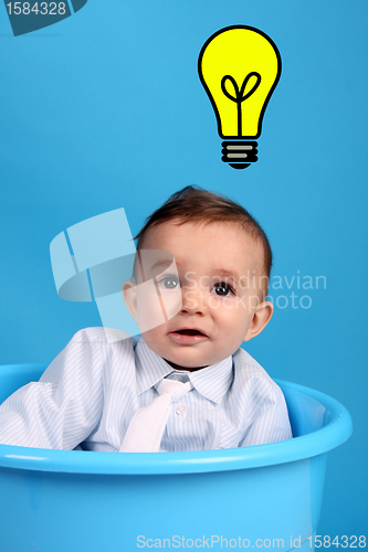 Image of baby on a blue bucket having idea, studio shoot