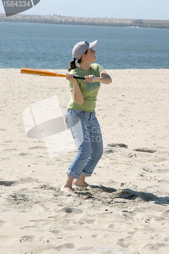 Image of playing baseball on the beach, sports photo