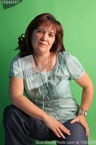 Image of fashion woman on green background. studio shot.