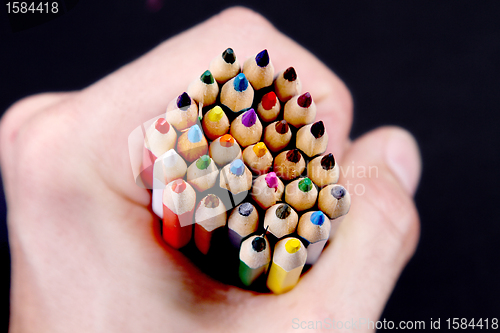 Image of Assortment of coloured pencils with shadow on white/back backgro