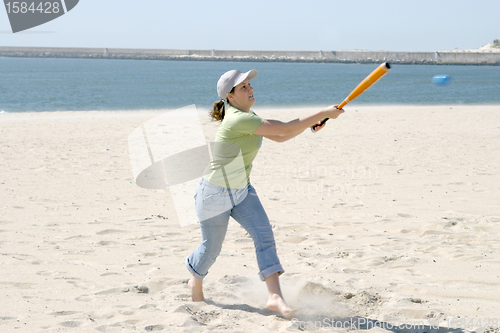 Image of playing baseball on the beach, sports photo