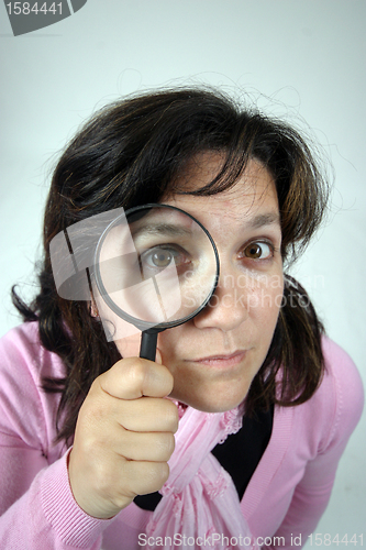 Image of Young businesswoman holding Magnifying Glass, business photo