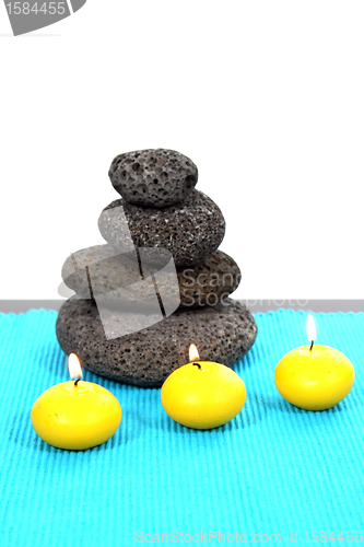 Image of candles and massage stones in a calm zen spa