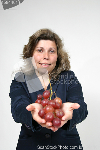 Image of beautiful woman with red grapes, healthy food