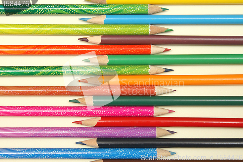 Image of Assortment of coloured pencils with shadow on white background