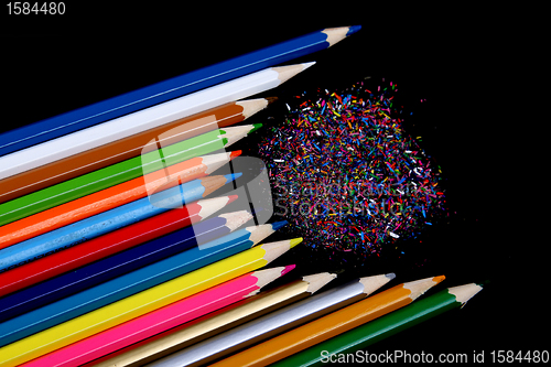 Image of Assortment of coloured pencils with shadow on white/back backgro