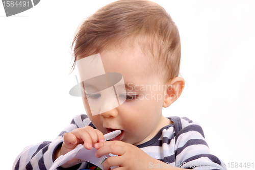 Image of beautiful baby biting, baby studio photo