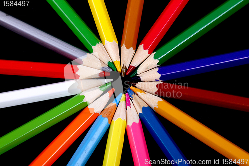 Image of Assortment of coloured pencils with shadow on white/back backgro