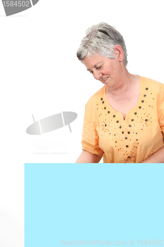 Image of mature woman holding blank board