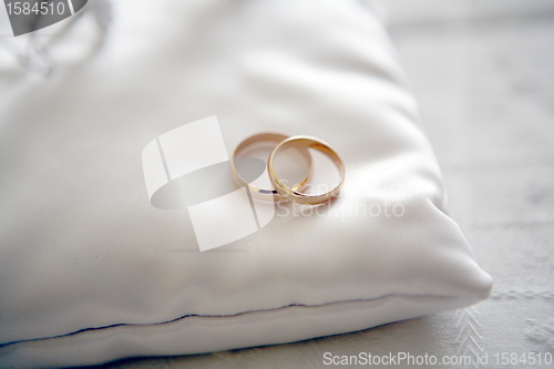 Image of Two wedding rings with white flower in the background, wedding p