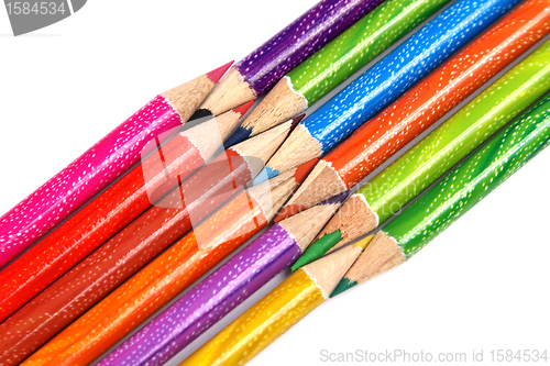 Image of Assortment of coloured pencils with shadow on white background