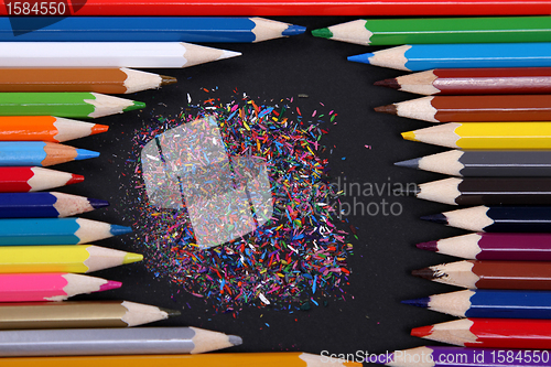 Image of Assortment of coloured pencils with shadow on white/back backgro