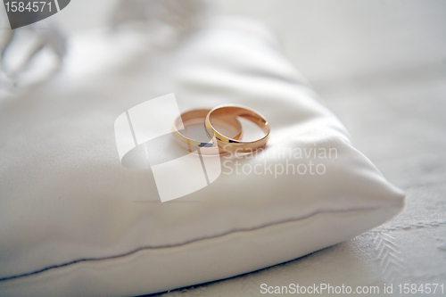 Image of Two wedding rings with white flower in the background, wedding p