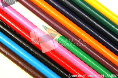 Image of Assortment of coloured pencils with shadow on white background