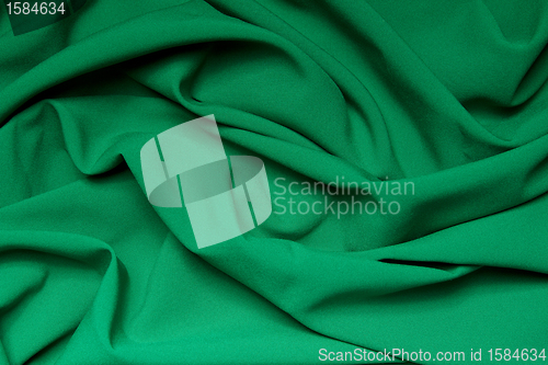 Image of The folds of a bright green cloth. Abstract Background