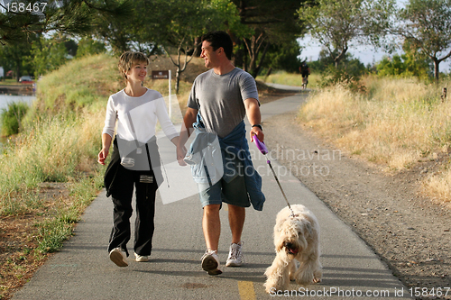 Image of Couple walking their dog