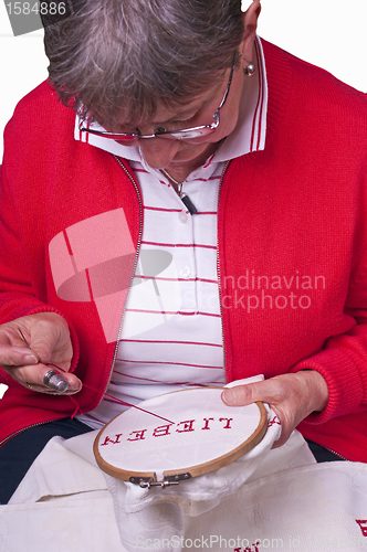 Image of pensioner does embroidery