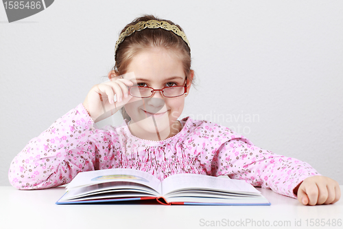 Image of Schoolgirl with glasses reading book