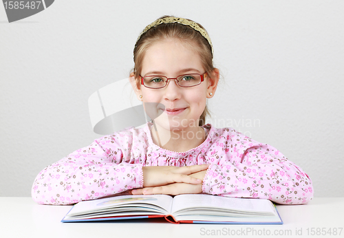 Image of Schoolgirl with glasses reading book