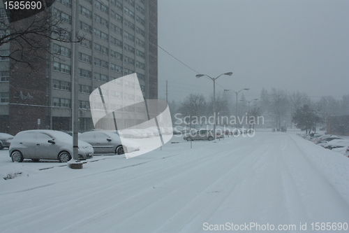 Image of Picture taken during a winter storm that passed by the city - snow covered a street