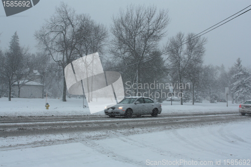 Image of Picture taken during a winter storm that passed by the city - cars slow because of the snow and sleet on the busy street