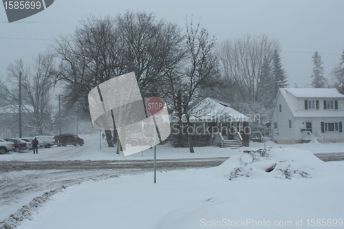 Image of Picture taken during a winter storm that passed by the city - snow  covered a busy intersection