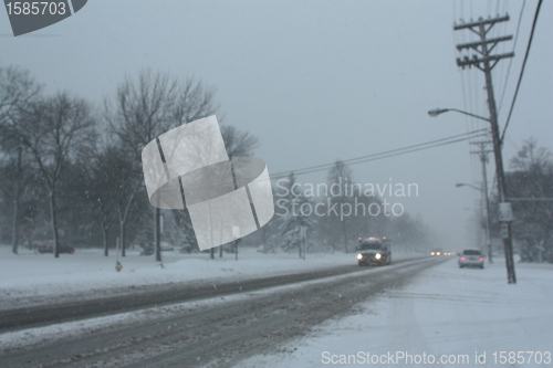 Image of Picture taken during a winter storm that passed by the city - snow and sleet covered a busy street