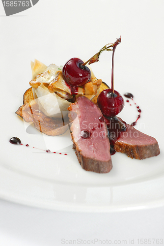 Image of grilled meat decorated with cherry