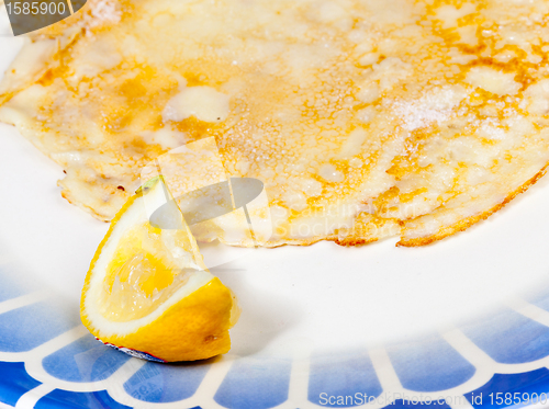 Image of Pancake with lemon on blue plate
