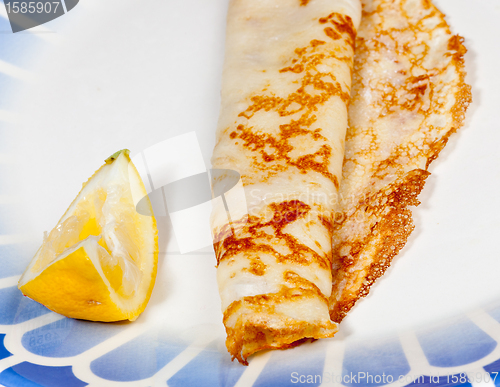 Image of Pancake with lemon on blue plate