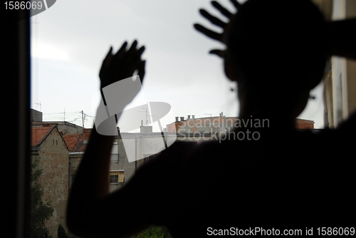 Image of Female silhouette by window