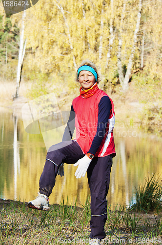 Image of Woman making of the stretching in full nature 