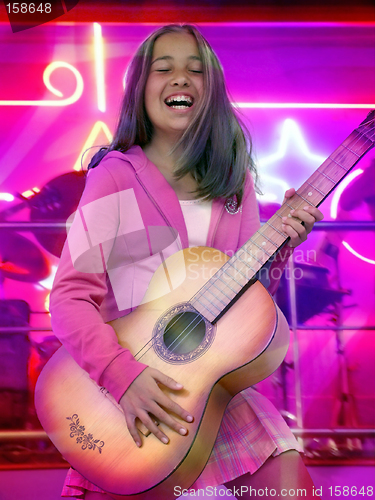 Image of Happy teen girl with guitar