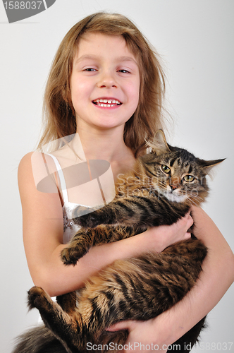 Image of happy child holding a cat in hands
