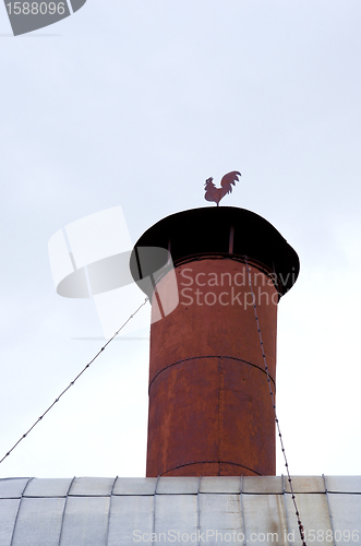 Image of rusty tin chimney rooster weather vane weathercock 