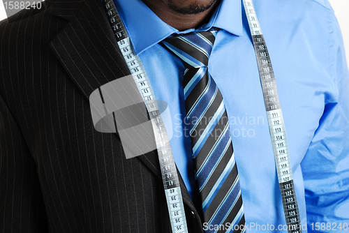 Image of Business man with tape measure 