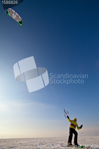 Image of Ski kiting and jumping on a frozen lake