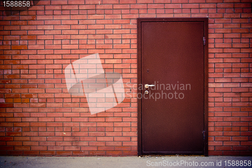 Image of Red brick wall and the iron closed door