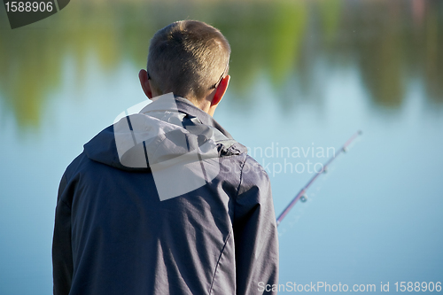 Image of fisher on a morning foggy lake