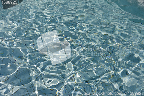 Image of beautiful clear pool water reflecting in the sun