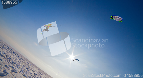 Image of Ski kiting and jumping on a frozen lake