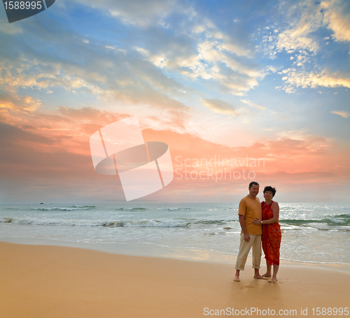 Image of couple on the beach at sunset