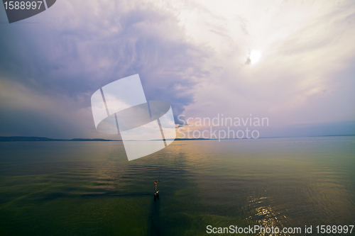 Image of dark landscape with a river of green water