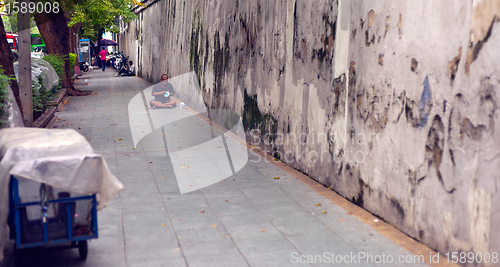 Image of Homeless Man bundled sleep in a city doorway